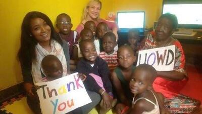 University of Wollongong in Dubai team members with orphans in Uganda who are benefiting from the computer program. Photo courtesy University of Wollongong