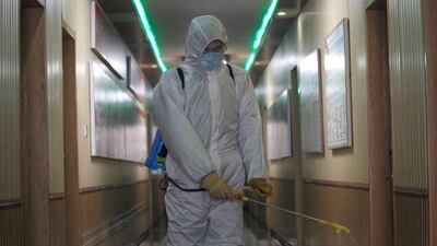 A man of the Hygienic and Anti-epidemic Center in Phyongchon District disinfects a corridor of a building in Pyongyang. AP Photo