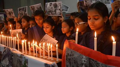 Indian schoolgirls offer prayers for the victims of the Nepal earthquake at a school in Amritsar on April 27, 2015. India is home to a sizeable number of Nepalese migrants and has close ties with its northern neighbour. Narinder Nanu / AFP