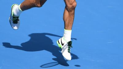Switzerland's Roger Federer casts a shadow on court as he plays a forehand return during his men's singles match against Czech Republic's Tomas Berdych on day nine of the 2016 Australian Open tennis tournament in Melbourne on January 26, 2016. AFP PHOTO / WILLIAM WEST-- IMAGE RESTRICTED TO EDITORIAL USE - STRICTLY NO COMMERCIAL USE