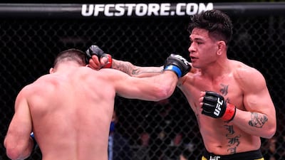 Maki Pitolo, right, punches Julian Marquez in their middleweight fight during the UFC 258 event at UFC APEX in Las Vegas, Nevada. Jeff Bottari / Zuffa LLC / UFC