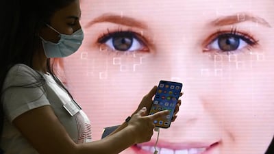 A fair hostess presents a Huawei P40 pro smartphone at the booth of Huawei during the Internationale Funkausstellung IFA international trade show for consumer electronics and home appliances on September 3, 2020 at the fair grounds in Berlin. - A special edition of the fair, adapted to health security measures amid the novel coronavirus / COVID-19 pandemic, will be running from September 3 to 5, 2020. (Photo by Tobias SCHWARZ / AFP)