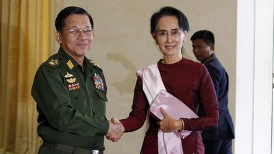 The Facebook account of Senior General Min Aung Hlaing, pictured with Aung San Suu Kyi, has been banned. Reuters