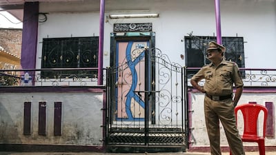 An Indian police officer stands outside a house in the Kasarvadavali area on the outskirt of Mumbai, India on February 28, 2016, where a 35-year-old man was suspected of murdering 14 family members before hanging himself. Divyakant Solanki/EPA