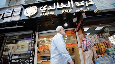 People walk past by a Syrian jewellery shop in Istanbul's Kucukcekmece district. Reuters