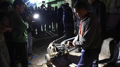 An Egyptian police officer in plainclothes rolls a piece of equipment to the site. AFP