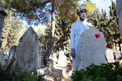 A member of Syrian Civil Defence, also known as White Helmets, at the funeral of Omar, 62, a displaced Syrian man who died of Covid-19. AFP