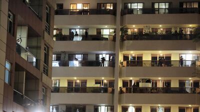 UAE residents cheering from their balconies and homes on Wednesday night at Al Mankhool area in Bur Dubai. Pawan Singh / The National