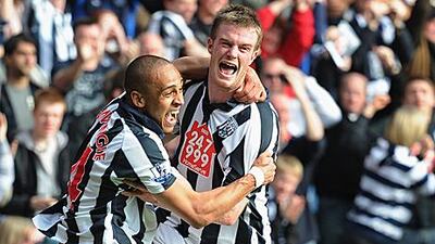 Chris Brunt, right, celebrates after scoring his second penalty against Liverpool yesterday.