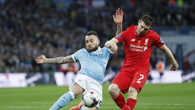 Liverpool’s James Milner has a shot at goal as Manchester City’s Nicolas Otamendi looks on. Reuters / Eddie Keogh