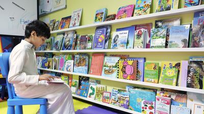 Saeed Salem, 8, enjoys a book the children’s library at Mafraq Hospital, Abu Dhabi. Sheikha Shamma has been setting up libraries for young patients in all the hospitals around the country as part of the Wanna Read? initiative. Delores Johnson / The National