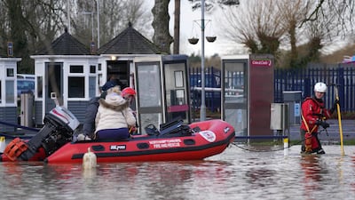 Emergency workers rescue people from houseboats at the Billing Aquadrome, in Northampton. PA