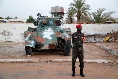 A Sudanese army soldier stands in front of a tank on display at the War Museum in Khartoum. AFP