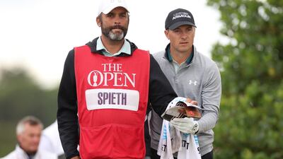 Jordan Spieth of the US reacts with his caddie Michael Greller after teeing-off on the third hole. Reuters