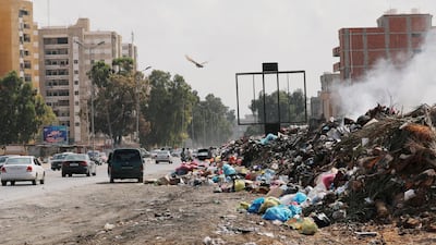 Cars pass next to the mounds of rubbish in Tripoli, Libya October 12, 2019. REUTERS/Ismail Zitouny