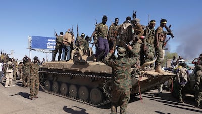 Sudanese troops celebrate the recapture of an oil refinery that had been held by the Rapid Support Forces for more than a year. Reuters