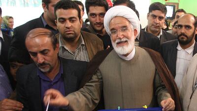 This file photo taken on June 12, 2009 shows Iranian presidential candidate Mehdi Karroubi casting his ballot at a polling station in Tehran. Atta Kenare / AFP
