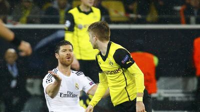 Real Madrid's Xabi Alonso reacts in front of Borussia Dortmund's Marco Reus during Tuesday night's match. Kai Pfaffenbach / Reuters / April 8, 2014