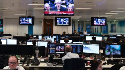 Traders in the City of London watch as Prime Minister Theresa May makes a statement to the House of Commons announcing the government's intention to delay the "meaningful" vote on the Brexit withdrawal agreement. AFP