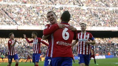 Koke, near, celebrates his opening goal against Barcelona for Atletico Madrid with teammate Antoine Griezmann on Saturday. Marta Perez / EPA