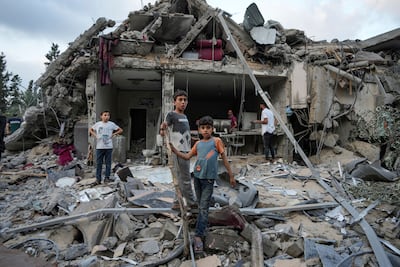 Palestinians assess the destruction after an Israeli air strike in Deir Al Balah in the Gaza Strip. AP