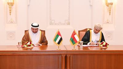 Shadi Malak, chief executive of Etihad Rail, and Abdulrahman Salim Al Hatmi, chief executive of Oman's state-owned logistics company Asyad, sign the co-operation deal to link the UAE and Oman by rail. Photo: Oman News Agency