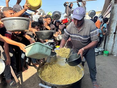 Palestinians collect food from a charity kitchen in Khan Younis, southern Gaza, on November 5. Reuters