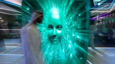 A visitor passes an exhibit at the Gitex Global technology event in Dubai. Victor Besa / The National