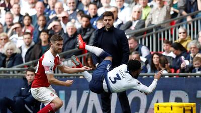 Tottenham's Danny Rose in action with Mustafi as Pochettino looks on. Reuters
