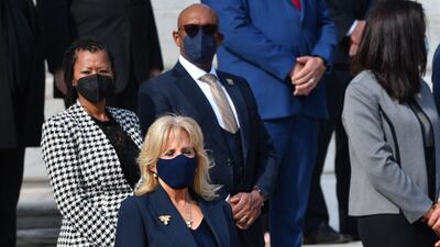 Jill Biden, in a belted navy dress and jacket, attends a Veterans Day event in Arlington, Virginia on November 11, 2021. AFP