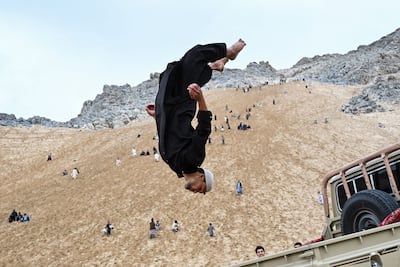 An Afghan parkour athlete performs a stunt at a sandy mountainside in Reg-e-Rawan, Kapisa province. AFP