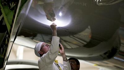 Employees work on the wing of a Boeing 787 Dreamliner during final assembly of the airplane at the company’s plant in Everett, Washington. Patrick Fallon / Bloomberg News