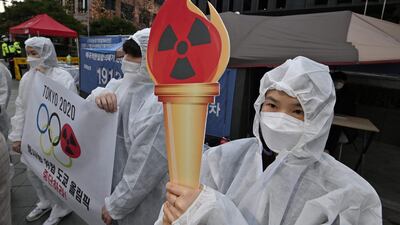 Anti-nuclear activists wearing white protective clothing stage a protest against the Tokyo 2020 Olympic Games. AFP