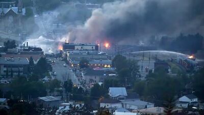 Firefighters douse blazes after a freight train loaded with oil derailed in Lac-Megantic in Canada's Quebec province. AFP Photo / François Laplante-Delagrave