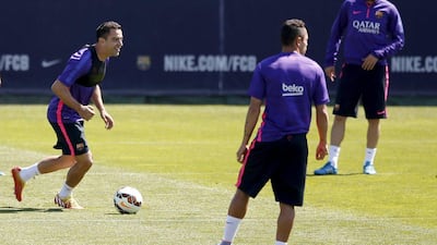 Xavi, left, takes part in a training session ahead of Barcelona's final Primera Liga game of the season. Gustau Nacarino / Reuters
