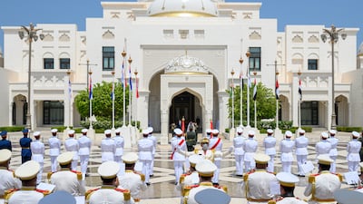 The national anthems of the UAE and Serbia play.