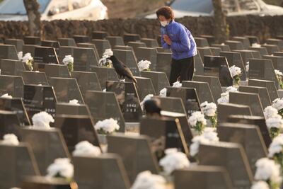 A bereaved family member visits a stone marker for her missing loved one at Peace Park in Jeju City on April 3. Yonhap / EPA