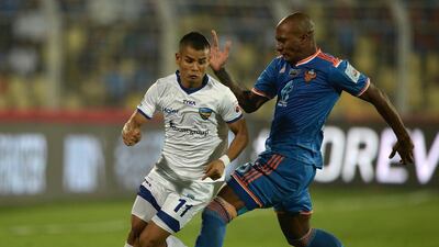 FC Goa player Gregory Arnolin tries to tackle Chennaiyin FC player Thoi Singh during the Indian Super League final in December. Punit Paranjpe / AFP