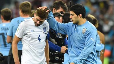 Luis Suarez of Uruguay consoles his Liverpool teammate Steven Gerrard of England after Uruguay defeat England 2-1 on Thursday at the 2014 World Cup. Ben Stansall / AFP
