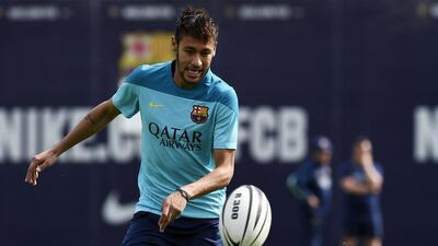 Barcelona’s Brazilian forward Neymar da Silva Santos Junior plays with a rugby ball during a training session at the Sports Center FC Barcelona Joan Gamper in Sant Joan Despi, near Barcelona on April 15, 2014, on the eve of their Spanish Copa del Rey final football match against Real Madrid. AFP PHOTO/ LLUIS GENE