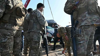 Lebanese army soldiers secure the site of an Israeli drone attack that targeted a vehicle on the highway of Saadiyat, south of Beirut. AFP