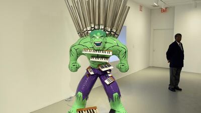 A security guard next to a sculpture titled “Hulk” during a press preview of “Jeff Koons: A Retrospective a exhibition his work at the Whitney Museum of American Art June 24, 2014. The show which spans the artist three decade career and will fill nearly the entire museum from June 27 through until October. 19. AFP