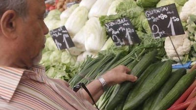 A man selects a cucumber at a vegetable stall. A virulent form of the E coli bacterium blamed on infected cucumbers from Spain has killed 11 people in Germany, while 300 more fell sick. Herwig Prammer / Reuters