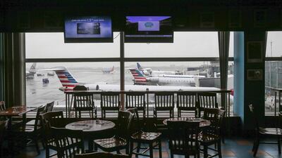 Empty chairs are seen at a restaurant in the central terminal of LaGuardia Airport in the Queens borough of New York. Shannon Stapleton / Reuters