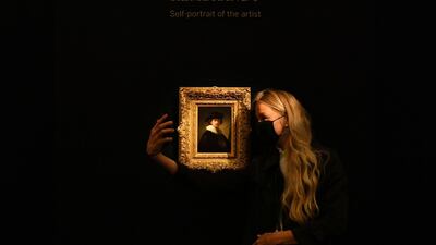 A visitor poses as she takes a selfie with 'Self Portrait' by Dutch master Rembrandt during a media preview for 'Rembrandt to Richter' at Sotheby's auction house in London, Britain. Reuters