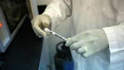 Faiz Mohammed Eltayeb Ali performs a test at the Forensic Science Department.