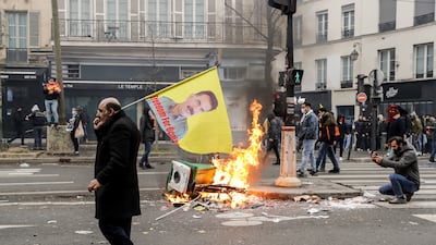 A man carries a flag showing the face of Abdullah Ocalan, the founder and leader of the PKK, at a protest in Paris on Saturday. EPA