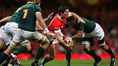 James Hook of Wales is tackled by Ryan Kankowski of South Africa during the match at the Millennium Stadium in Cardiff.