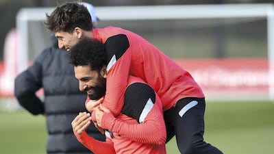 Mohamed Salah lifts Kostas Tsimikas during a Liverpool training session ahead of their return Champions League match against Real Madrid. Getty
