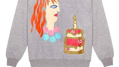 Tata Naka’s grey jumper with a S*uce 10-year anniversary cake. Courtesy: S*uce